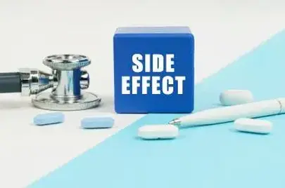 Medical concept. On a white and blue surface are pills, a stethoscope, a pen and a cube with the inscription - SIDE EFFECT: saxenda lawsuit